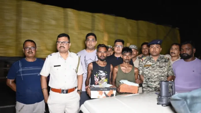Police display the 26 bottles of banned cough syrup seized during a late-night anti-drug operation in Naxalbari, in which two youths were arrested.